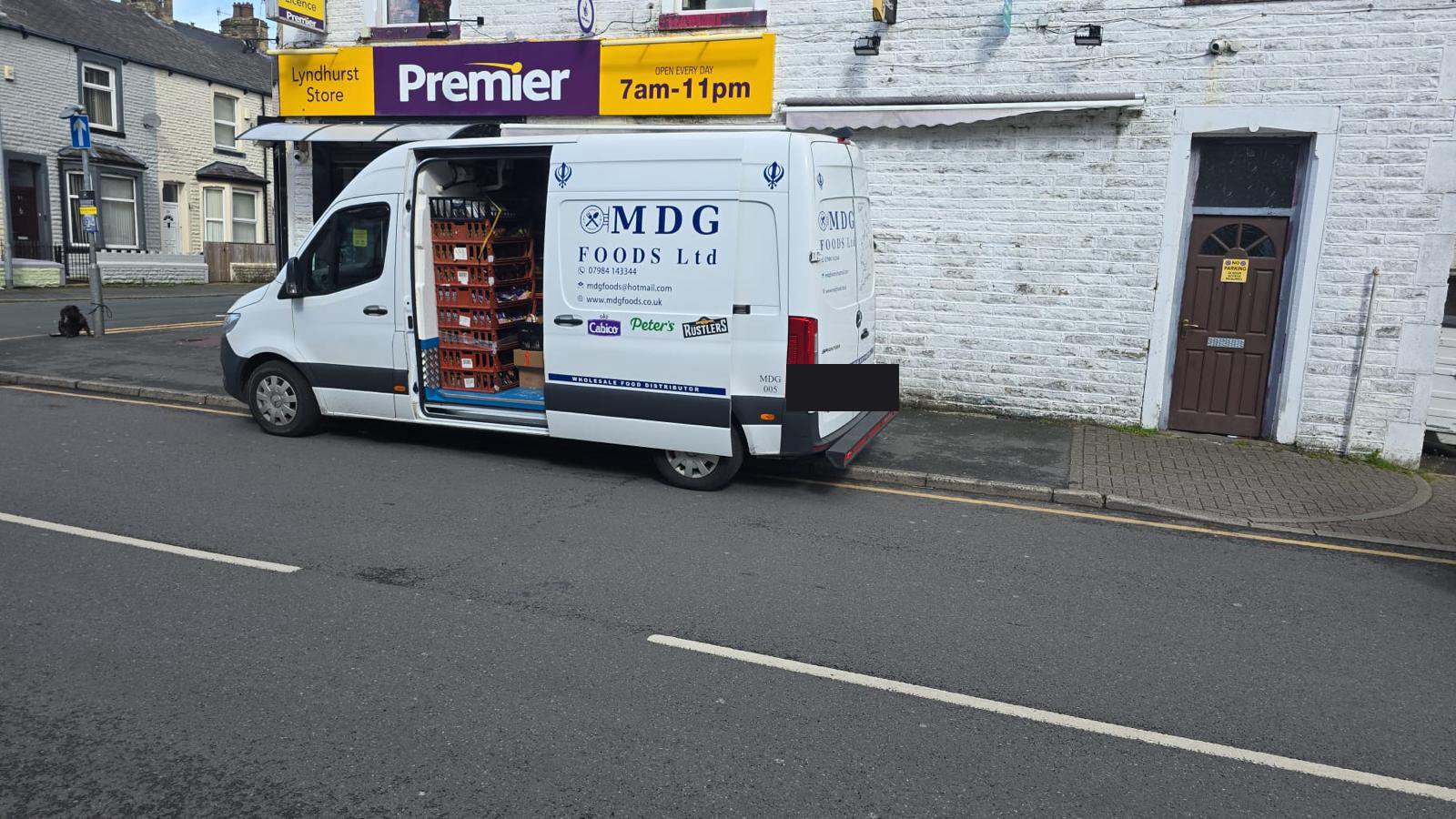 MDG Foods van loaded with stock making a delivery to a Premier store